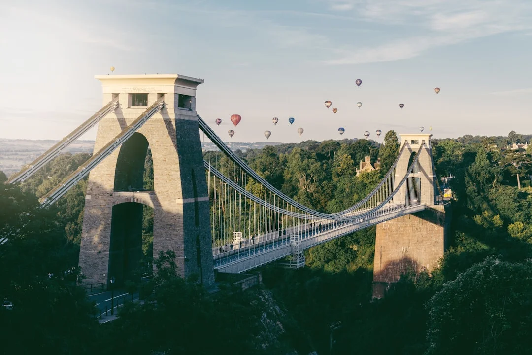 Hot air balloons floating in the sky above the Clifton Suspension Bridge in Bristol