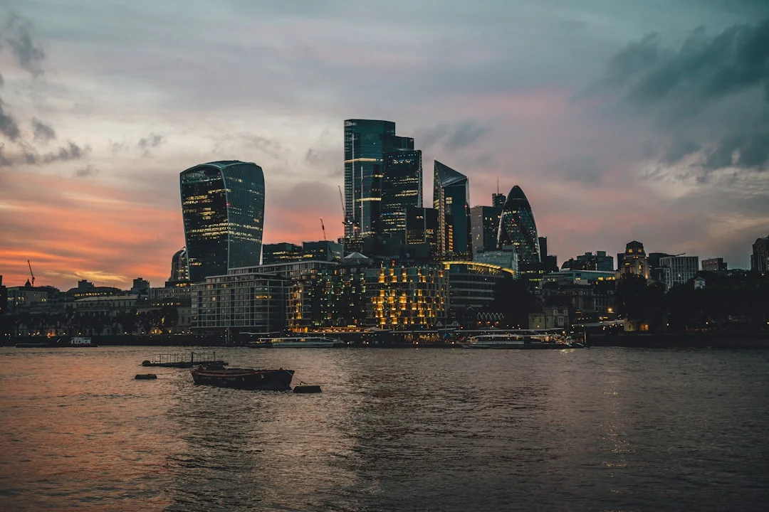 Skyscrapers of the City of London skyline at sunset, viewed from across the River Thames
