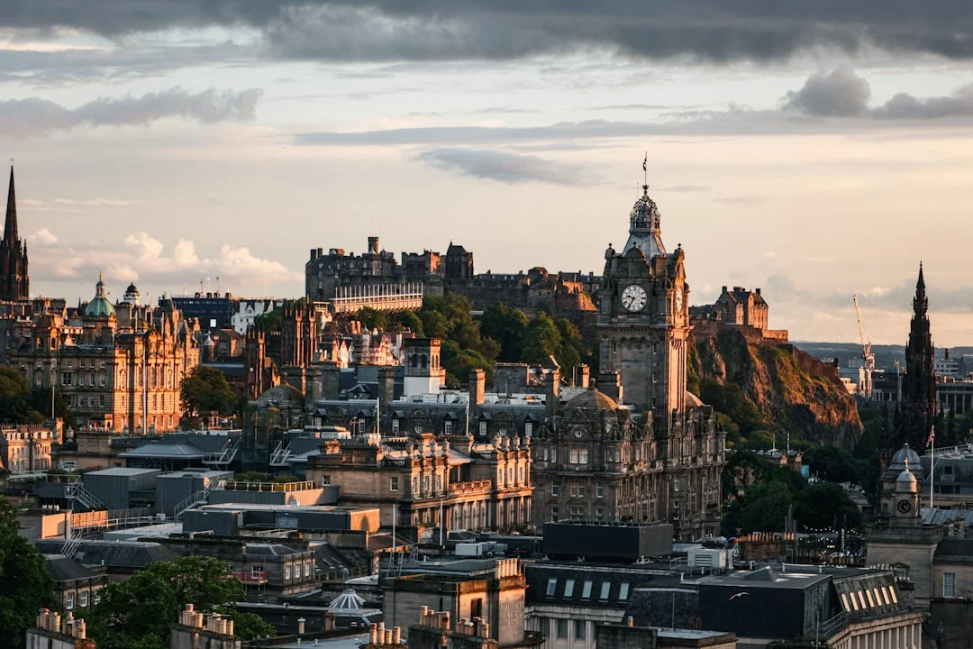 Golden hour view of Edinburgh's historic stone tenement buildings and the Balmoral Hotel clock tower