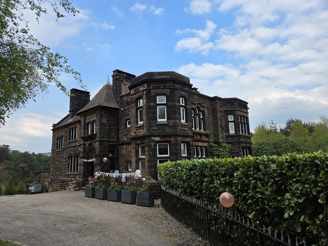 The grand exterior of Bell View Manor, a large house for group stays near London.