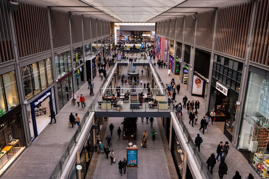 People walking through the modern Westgate shopping centre in Oxford on a busy Saturday