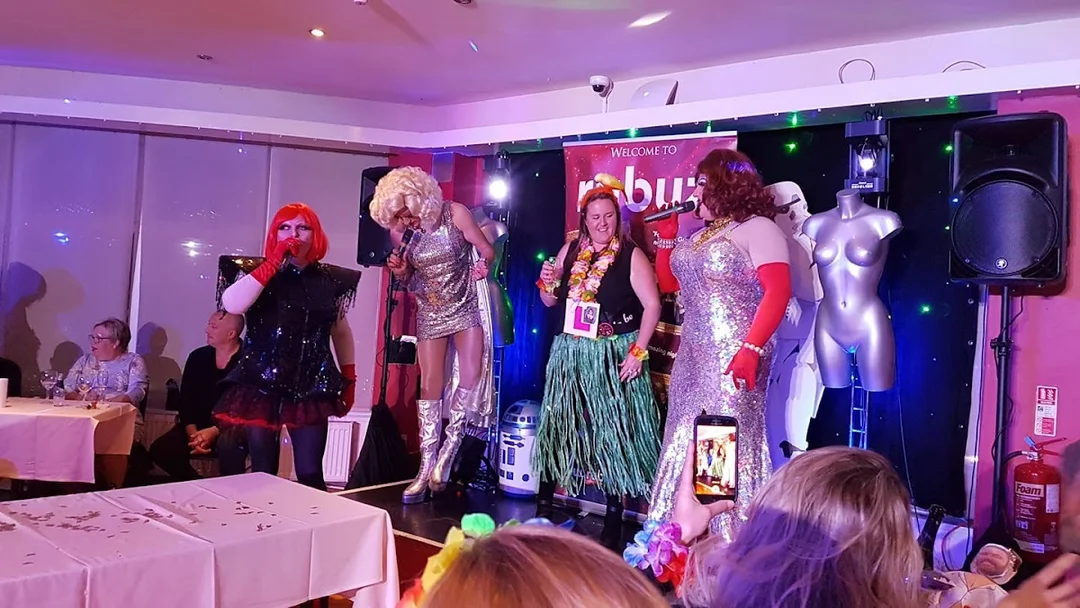 A drag queen performing on stage at Rubyz Cabaret in front of an enthusiastic hen party audience.