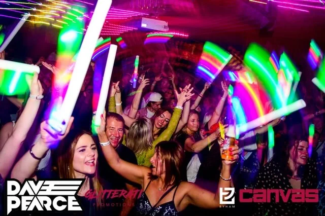 The stylish interior of Canvas bar in Bournemouth with groups of people enjoying cocktails and live music.