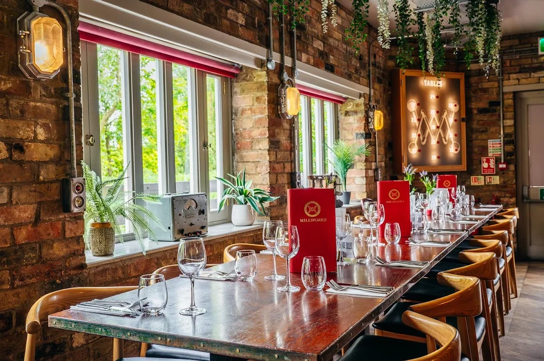 The interior of The Millworks restaurant in Cambridge, showing the iconic water wheel.