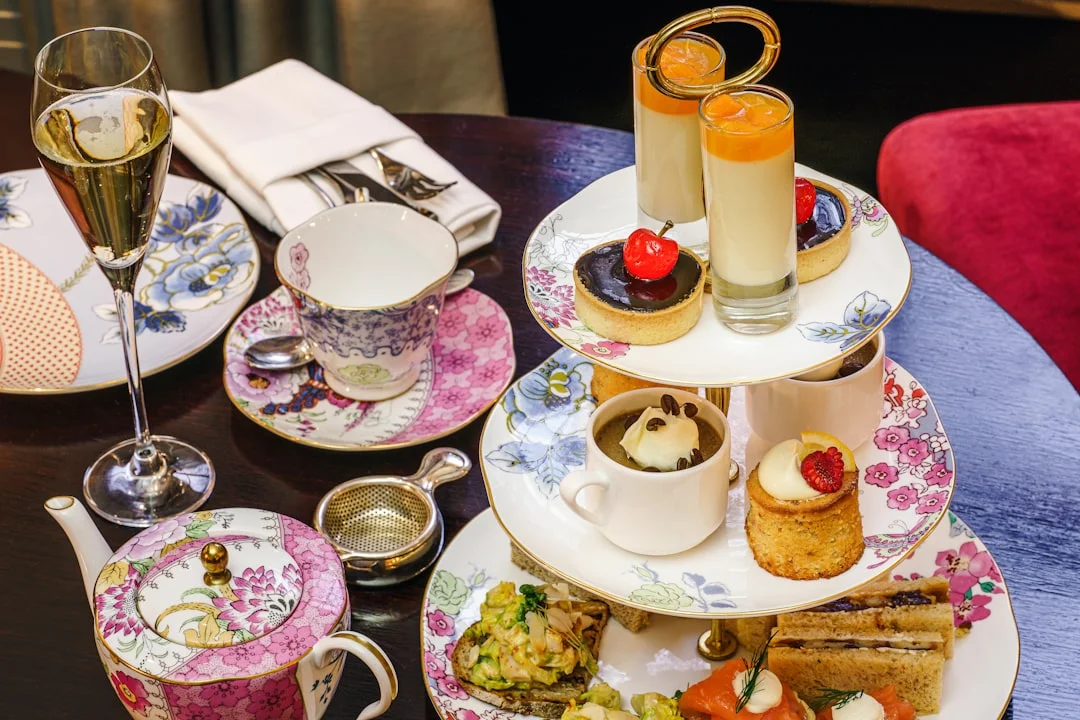 Elegant afternoon tea in Cambridge with a tiered stand of cakes, sandwiches, champagne, and scones