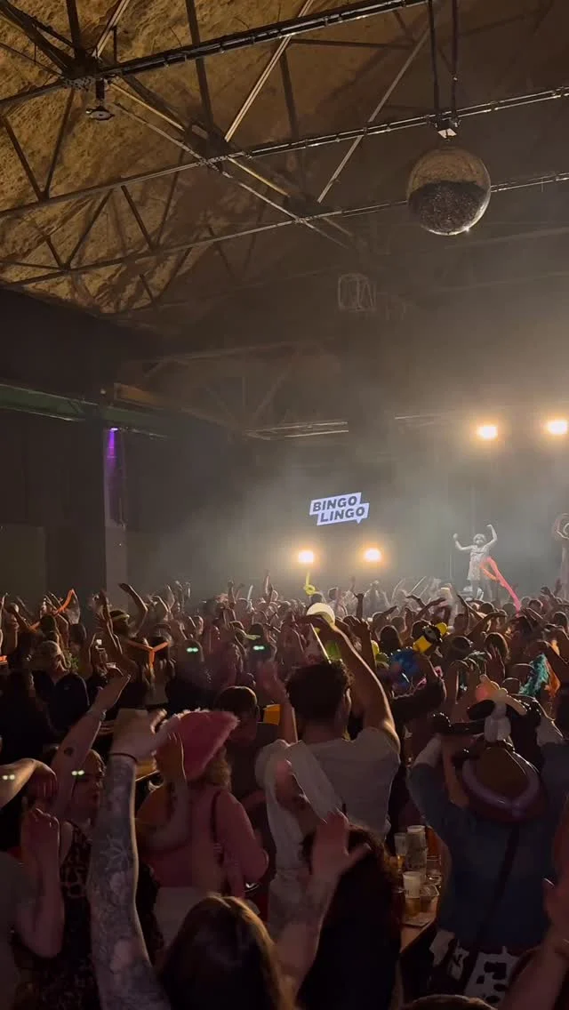 A large crowd at Bingo Lingo with confetti falling during a lively event in Cardiff.