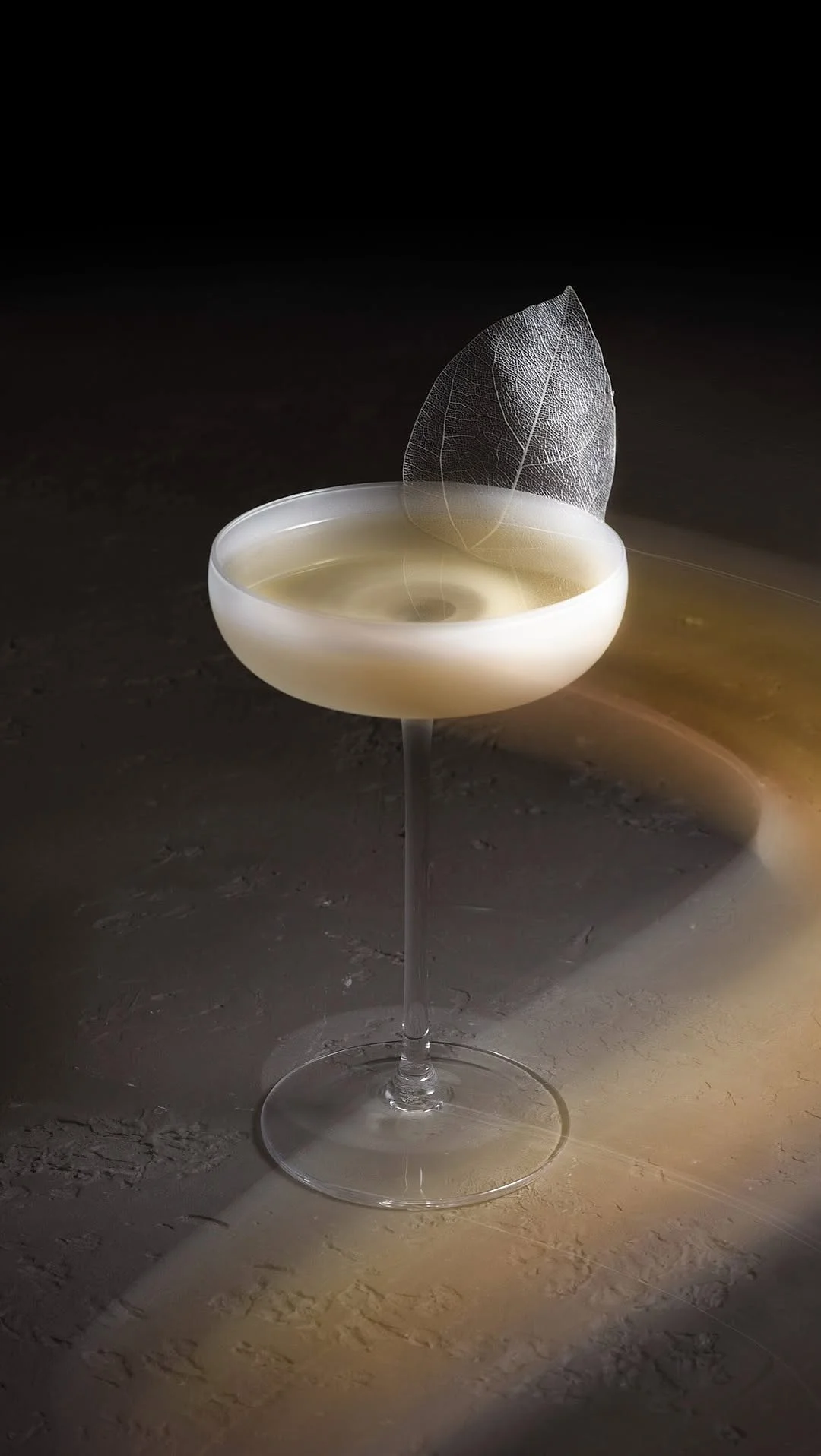 A bartender at The Alchemist creating a theatrical smoking cocktail for a hen party group.