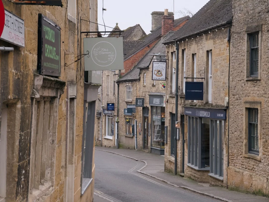 Historic Cheltenham street with traditional stone buildings and charming shops