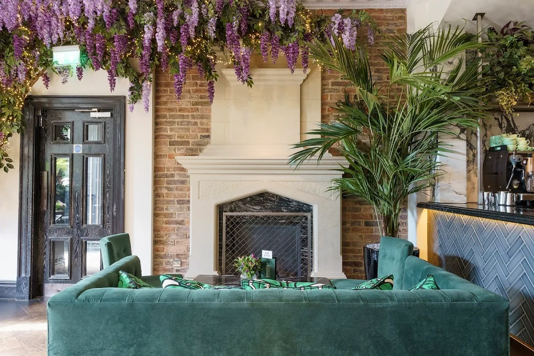 A group of friends posing for a photo in the stylish, leafy interior of Black Ivy in Edinburgh.