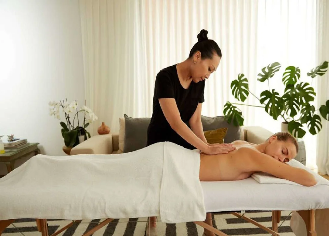 A mobile massage therapist from Blys setting up for a treatment in a hen party