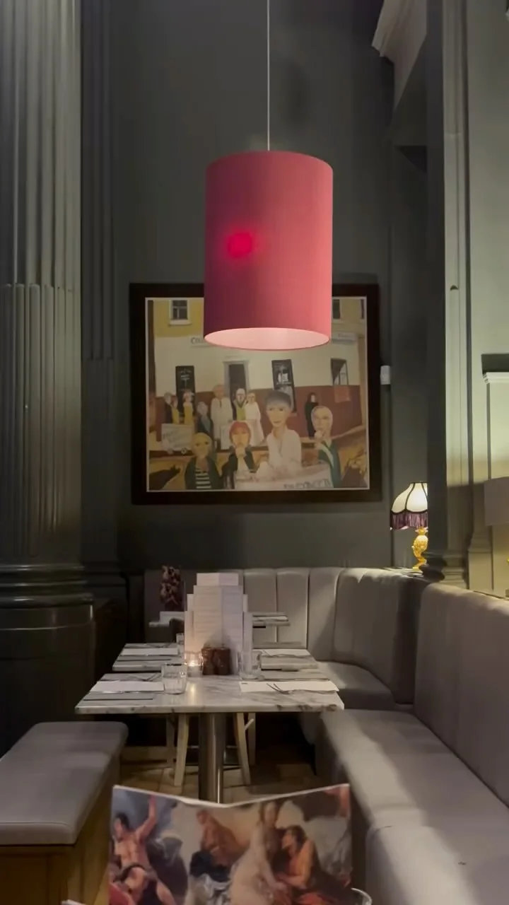The private dining room at Cannonball Restaurant with a long table set for a group, overlooking Edinburgh Castle.
