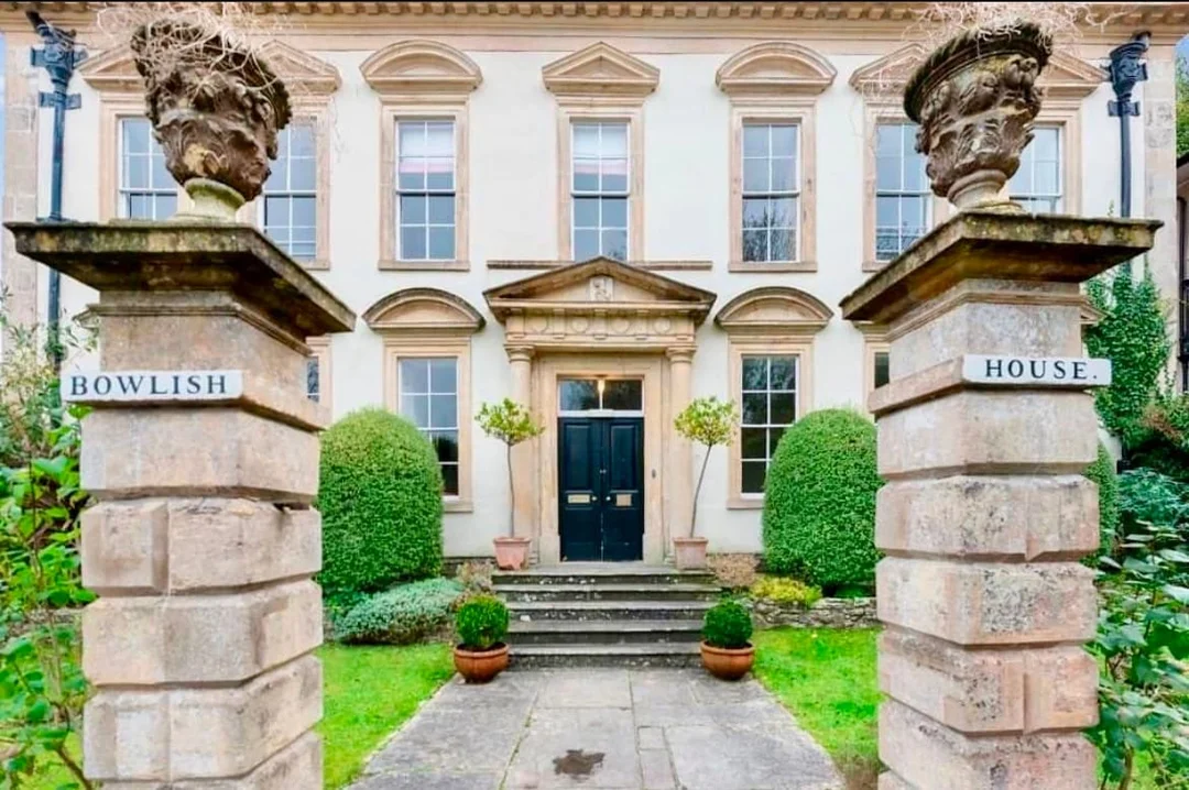 The grand exterior or a luxurious living room of the Georgian stately home in Somerset.
