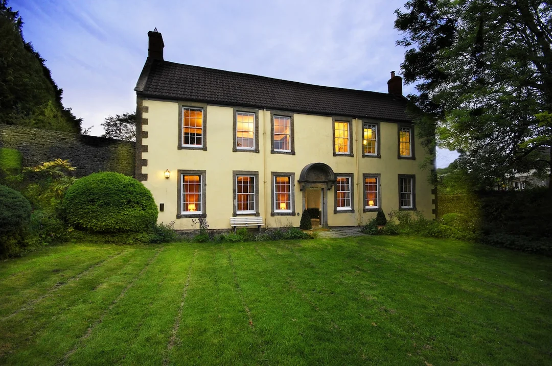 The impressive exterior or stylish living area of the Historic Manor hen party house in Somerset.