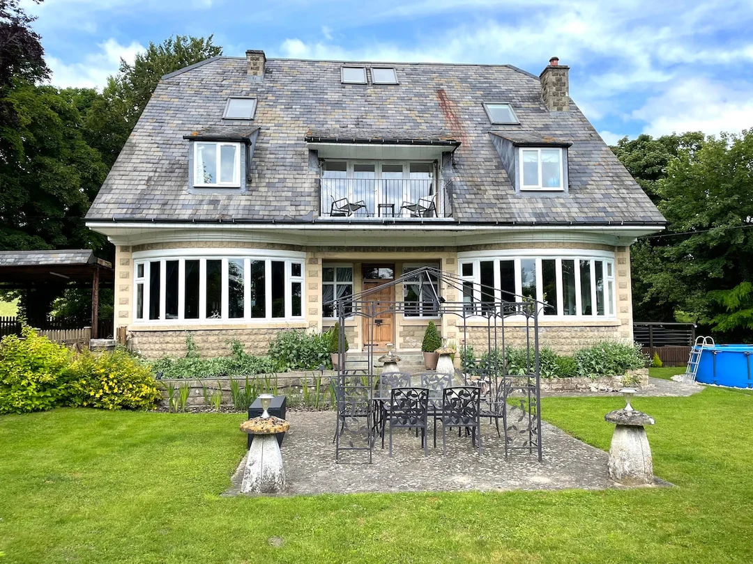 The stylish and spacious living area of Grovely Lodge, with comfortable seating for a large group.