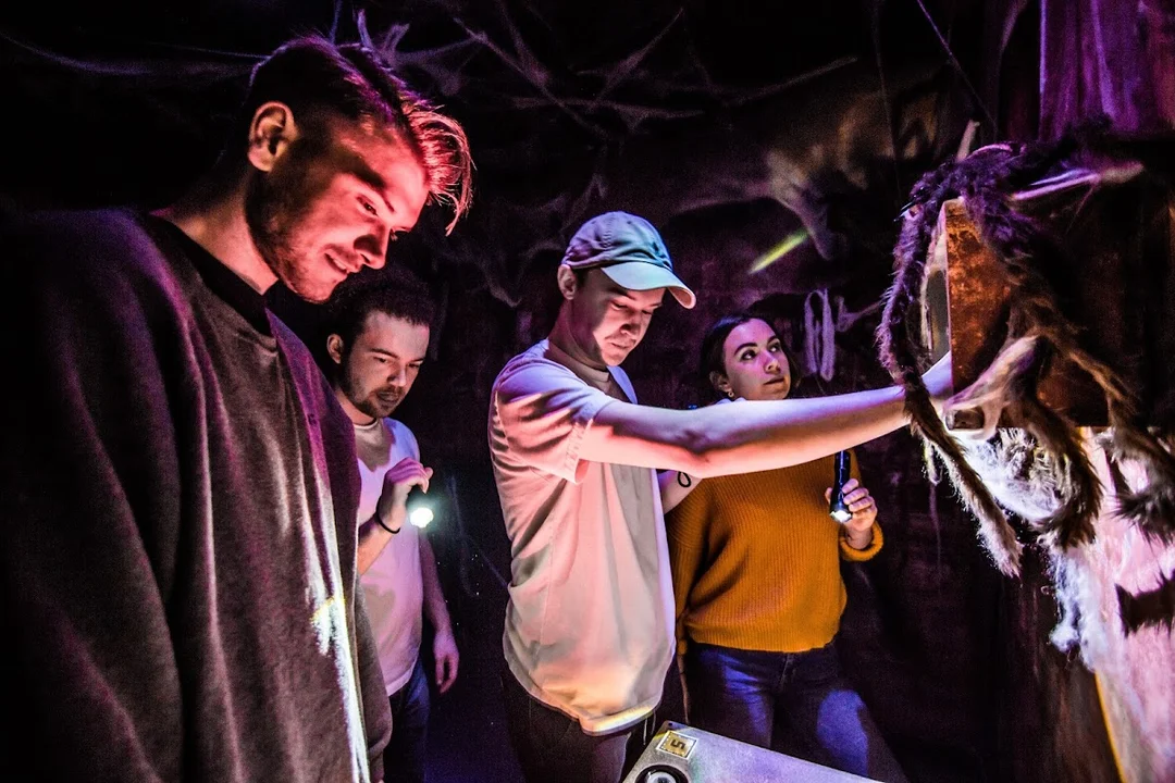 A group of friends working together to solve a puzzle in an escape room.