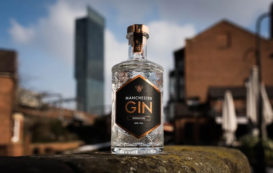 Guests at Manchester Gin distillery making their own gin in miniature copper stills.