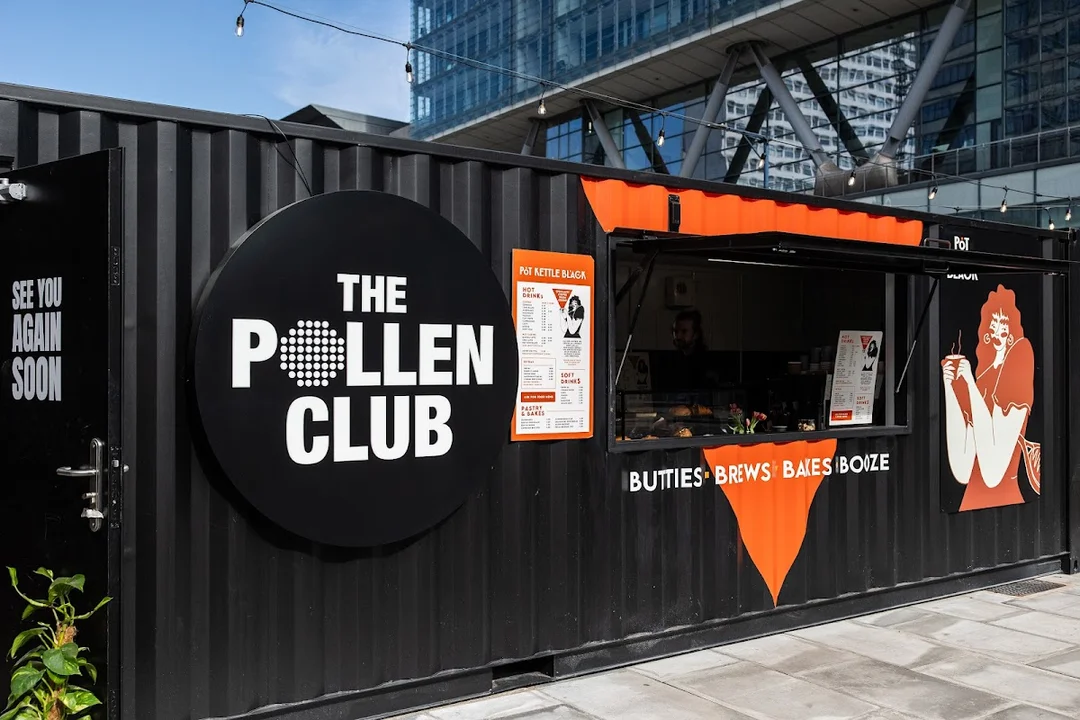 A group of friends playing padel tennis on a stylish court at The Pollen Club in Manchester.