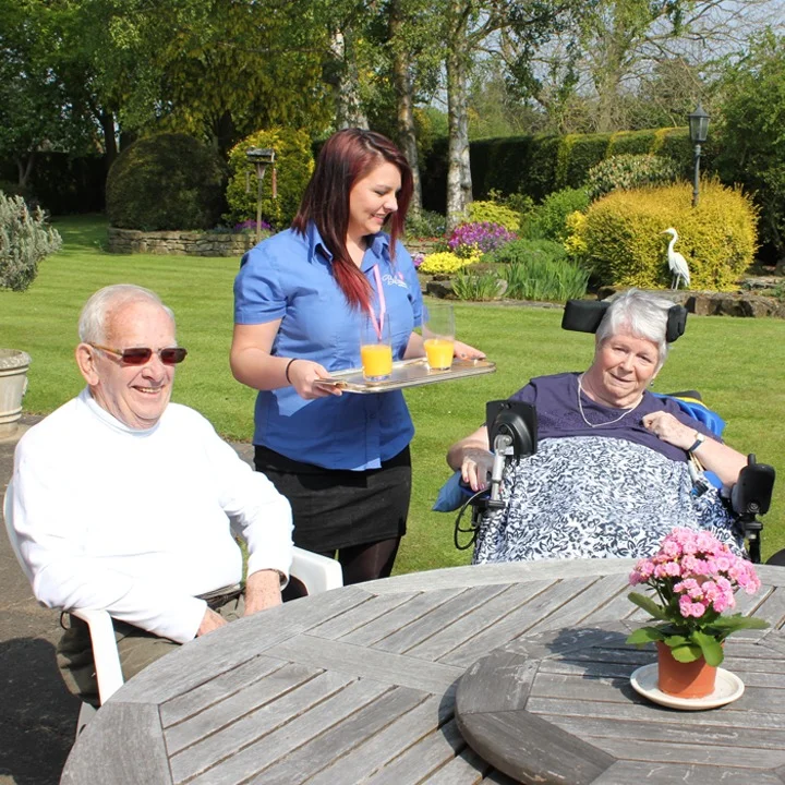 A mobile beauty therapist giving a relaxing manicure to a hen party guest in a private house.