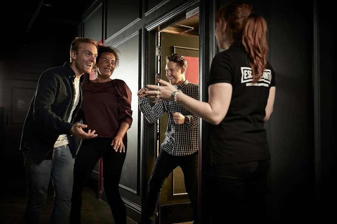A group of friends working together to solve a puzzle in a themed escape room.