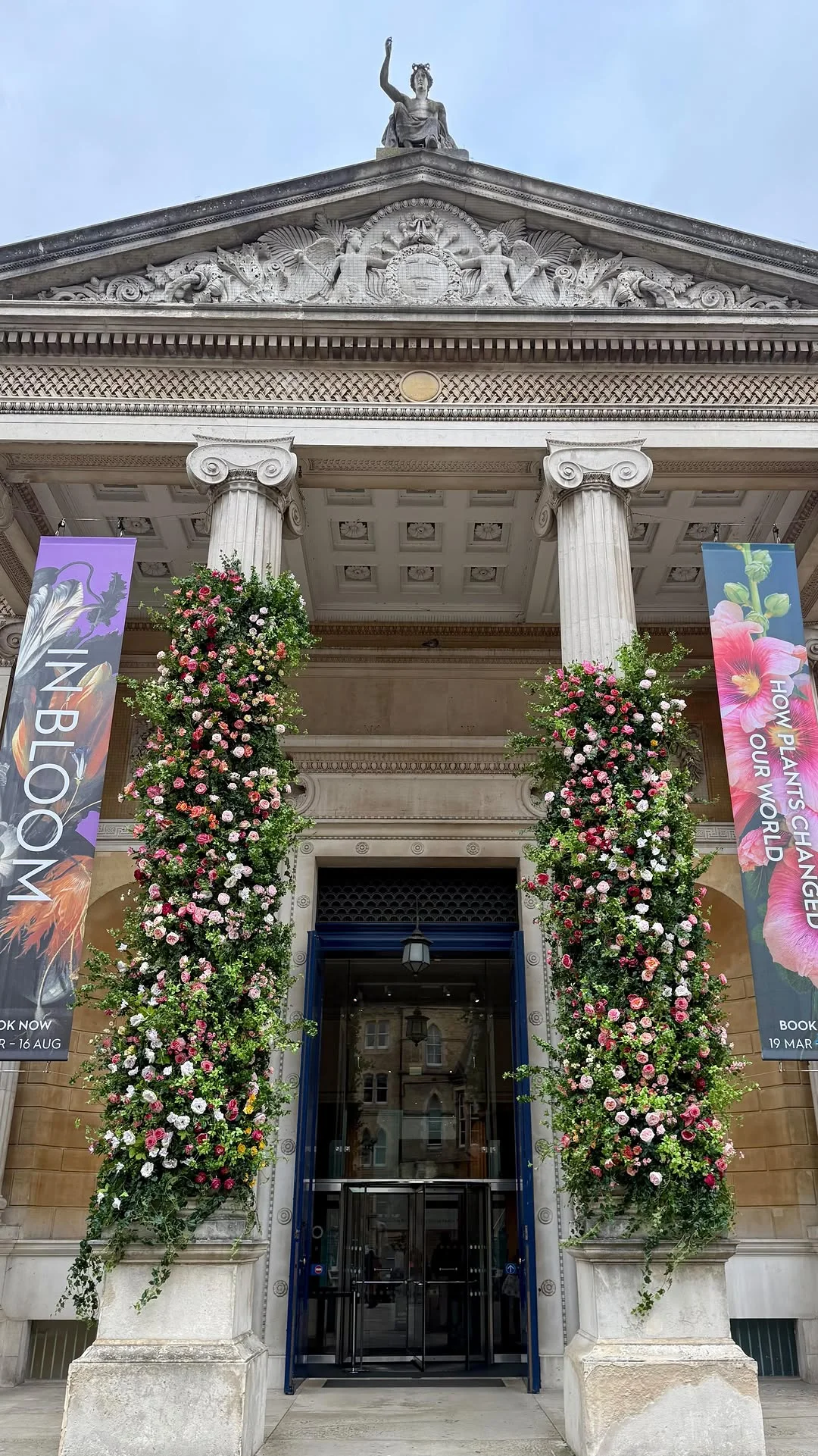 The grand neoclassical facade of the Ashmolean Museum in Oxford on a sunny day.