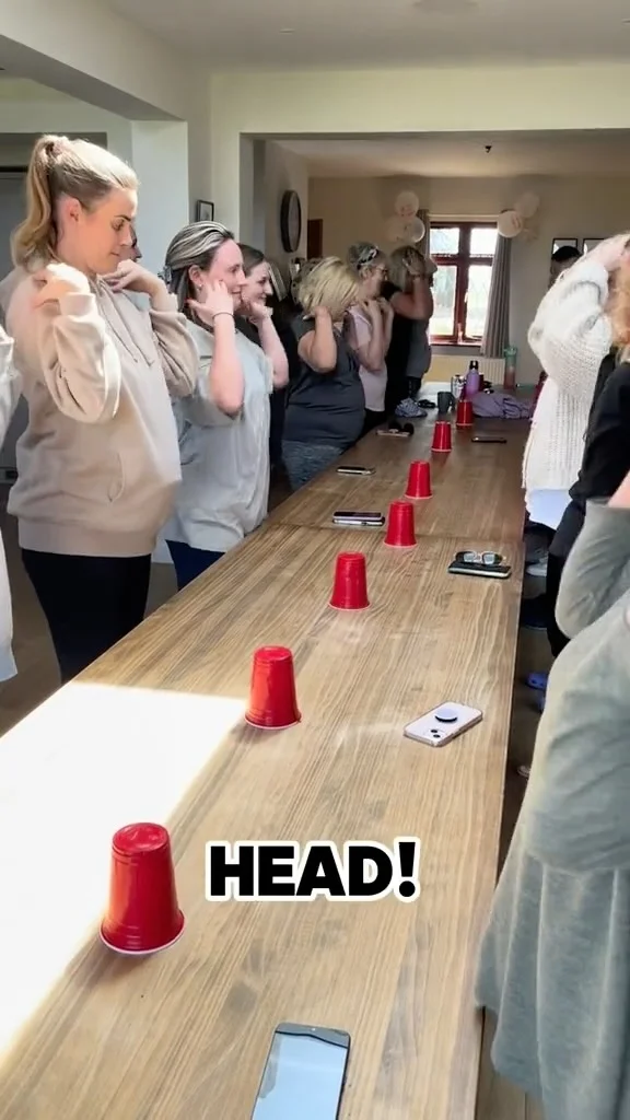 A hen party group having fun and laughing during a Laughtercise yoga session at their accommodation.
