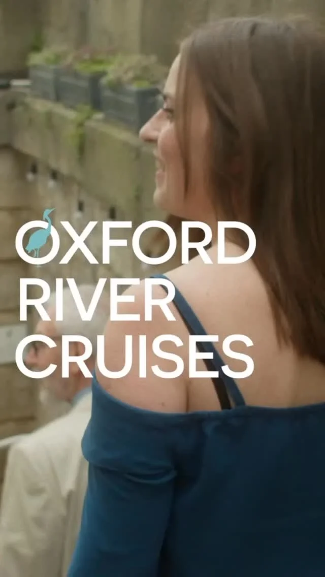 A hen party group enjoying a scenic prosecco cruise on an electric boat along the river in Oxford.