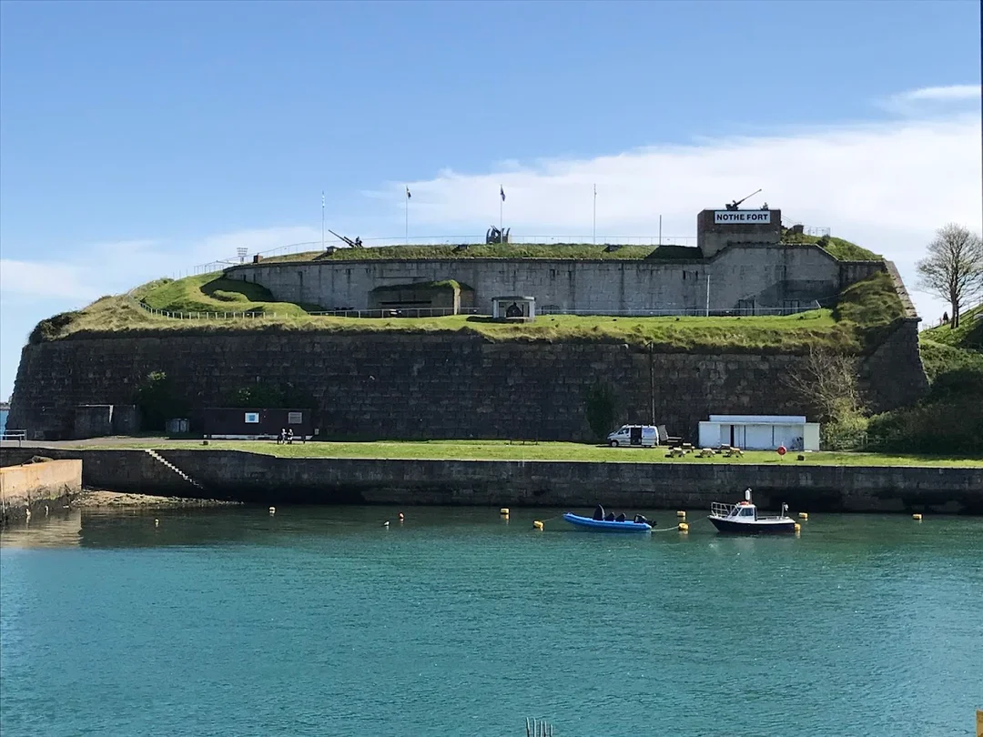 The historic Nothe Fort overlooking the sea in Weymouth, a scenic spot for a walk.